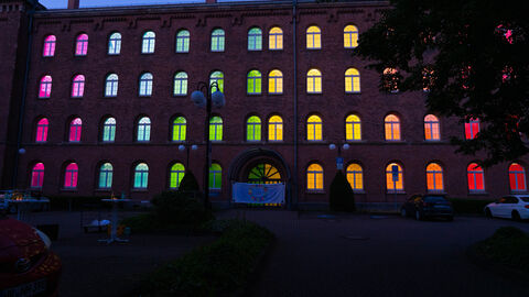 Zu sehen ist das Finanzamt Hersfeld-Rotenburg. Im Rahmen des Diversity-Tags wurden die Fenster mit bunter Farbe beklebt, so dass die Fenster in den Regenbogenfarben leuchten.